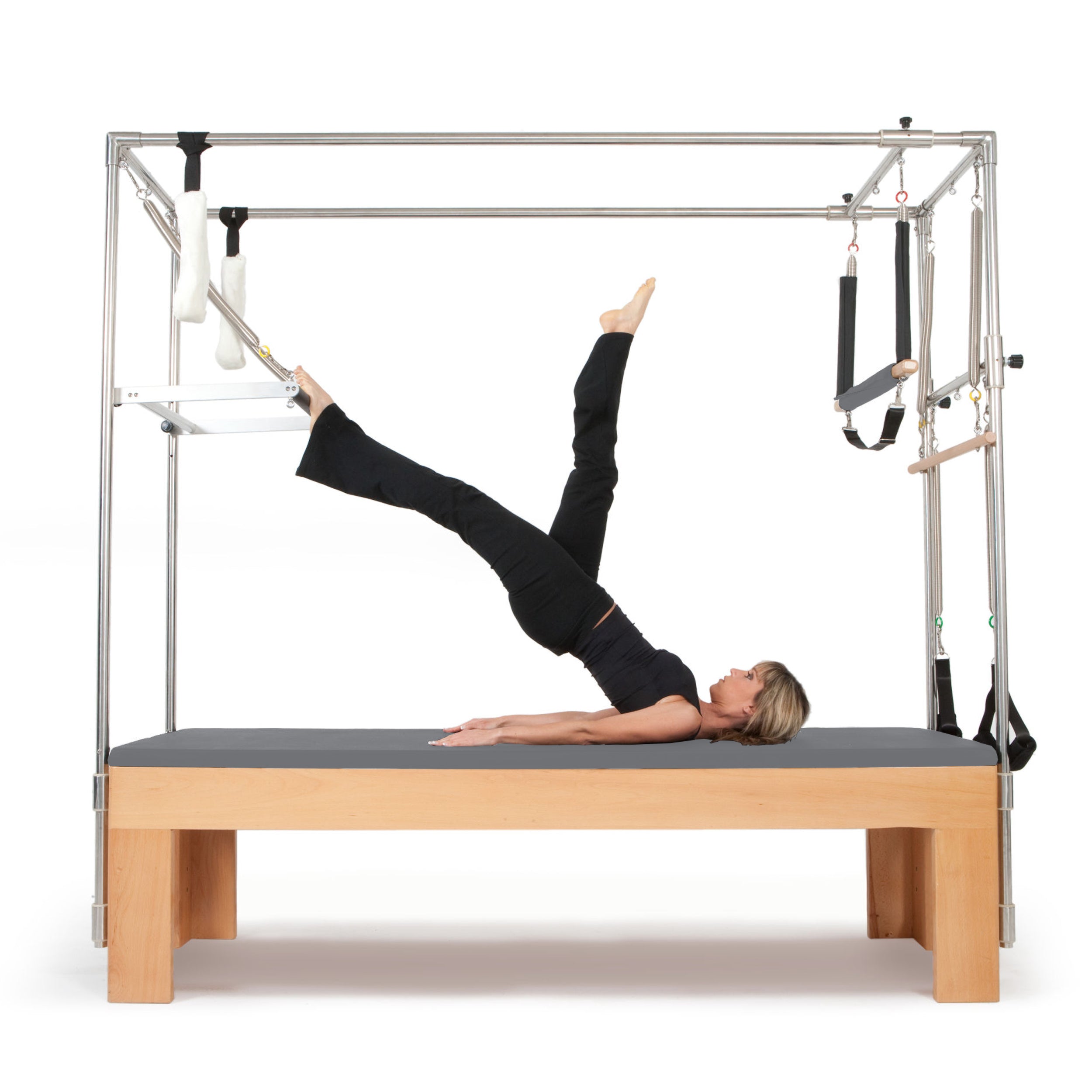 Professional Pilates Cadillac Reformer with trapeze tower, padded table, and adjustable attachments for full-body workout and rehabilitation exercises.