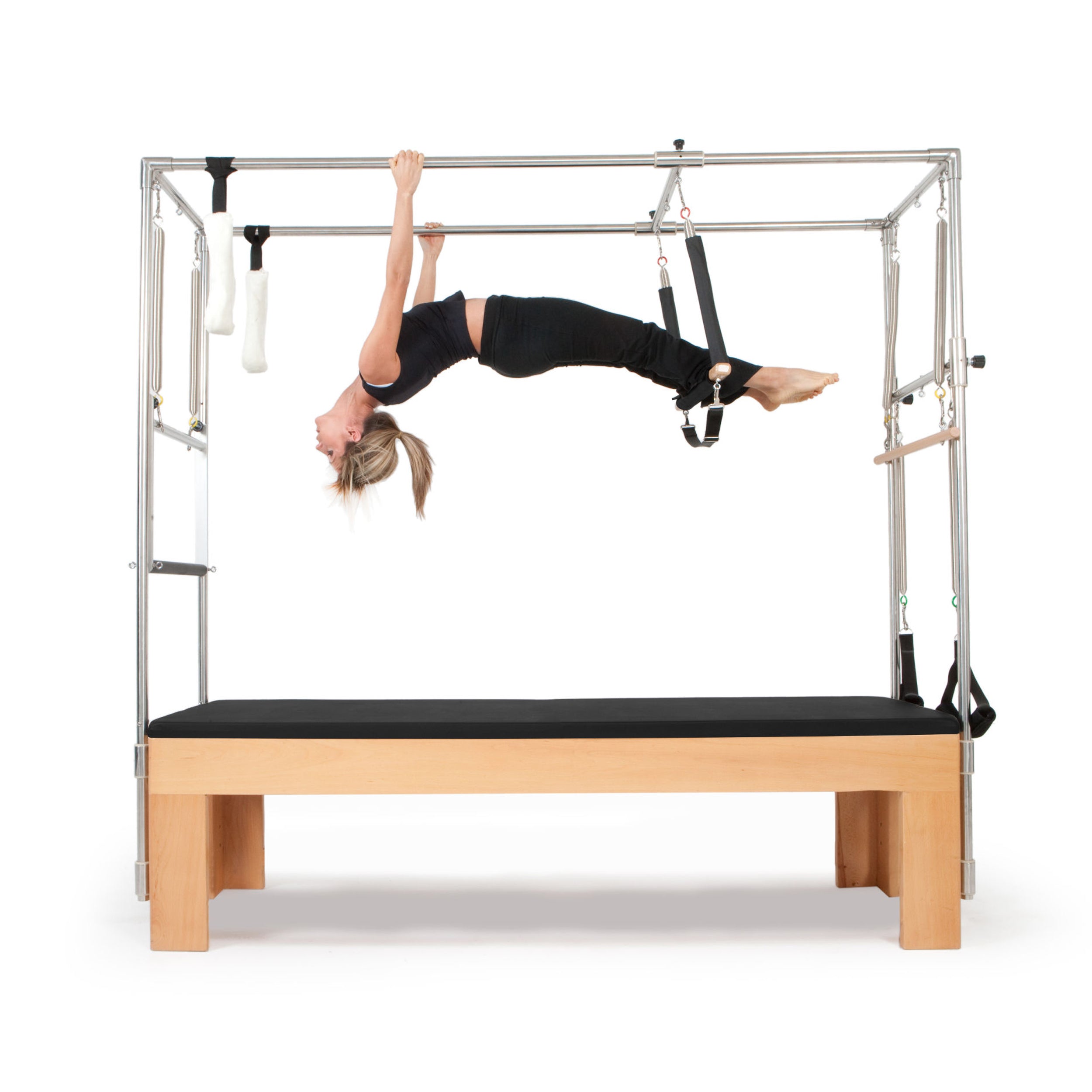 Professional Pilates Cadillac Reformer with trapeze tower, padded table, and adjustable attachments for full-body workout and rehabilitation exercises.