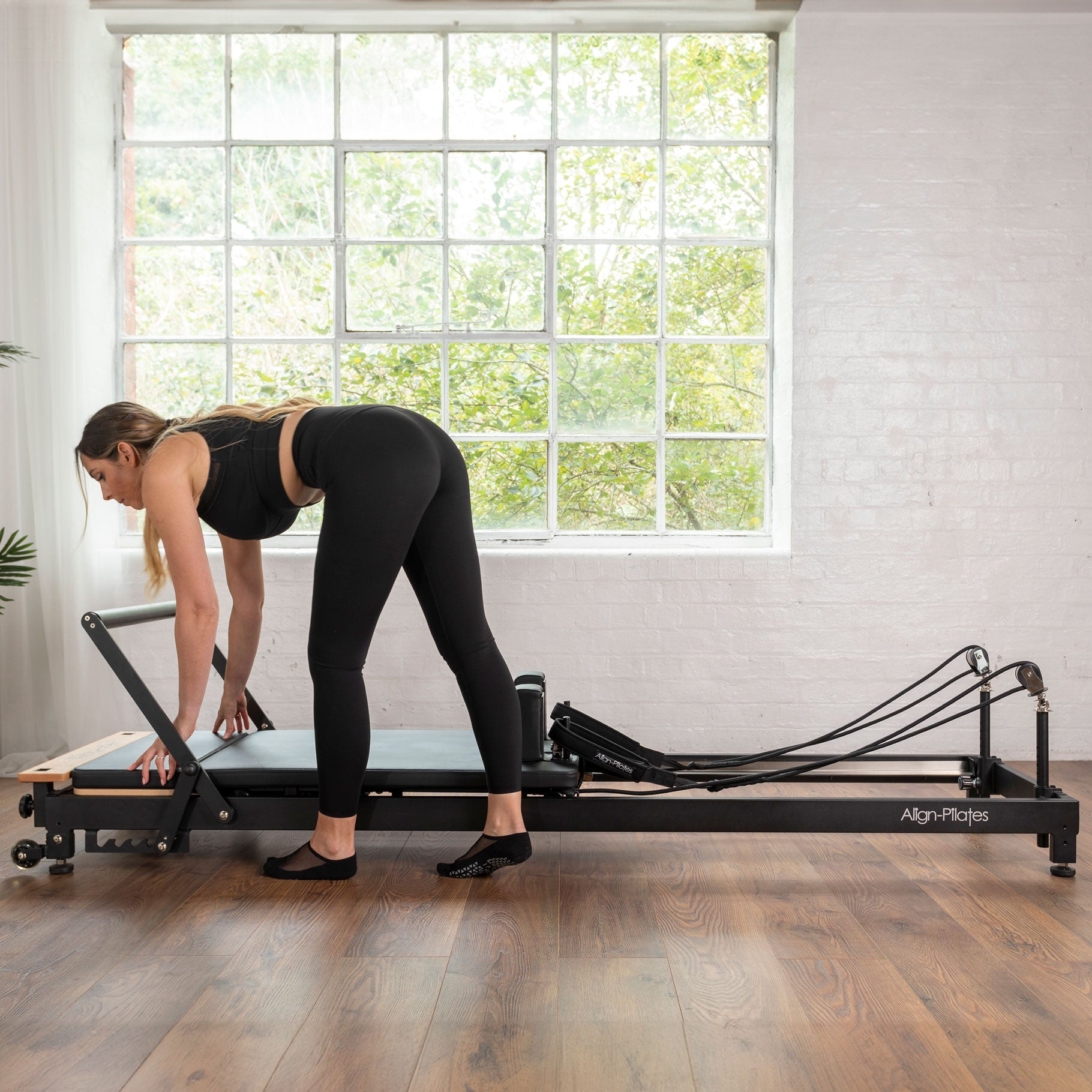 Practitioner using R8 Platform Extender for standing exercises