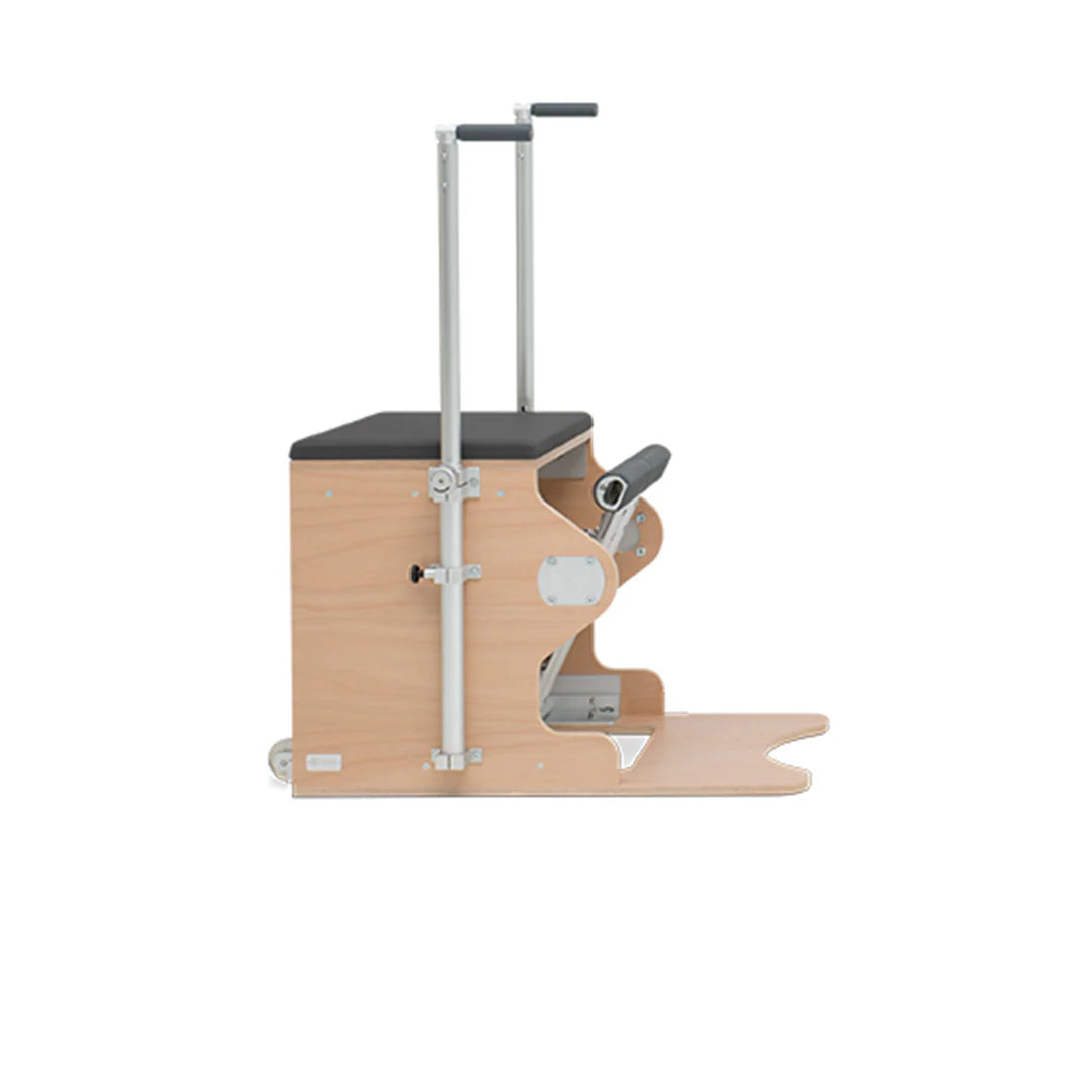 Pilates Wunda Chair with split pedals, handles, springs, and cushioned wooden seat.