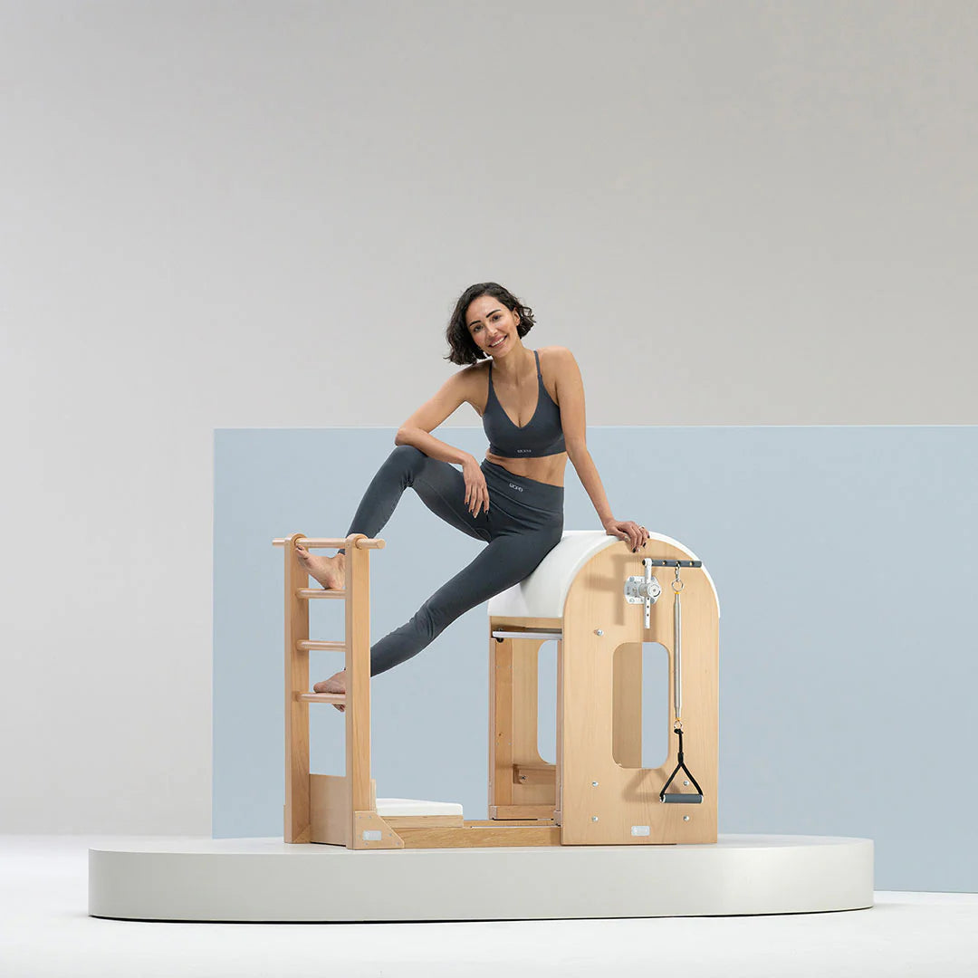 BASI Systems Ladder Barrel with adjustable curved cushion and standing platform for Pilates exercises