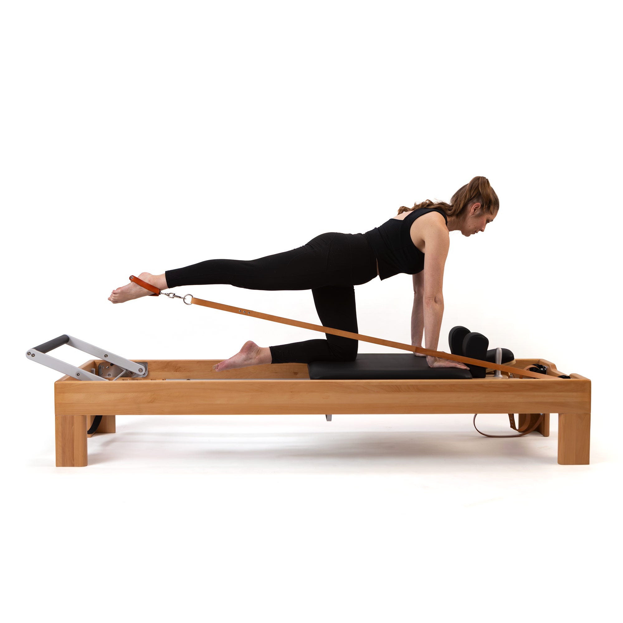 Artistry Reformer, beech finish, leather straps, in use