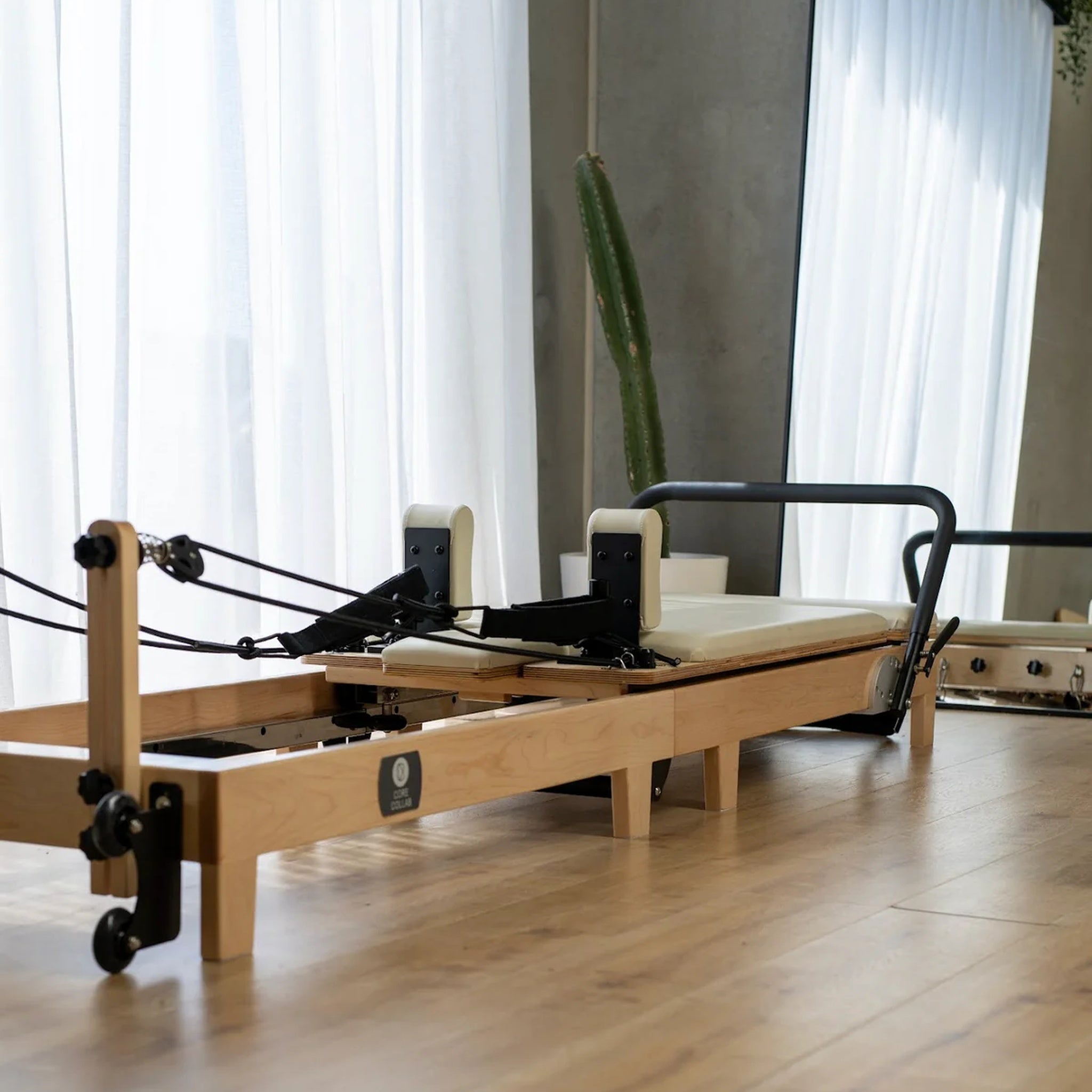 Spacious-studio-showcasing-the-Core-Collab-Eco-Foldable-Pilates-Reformer-for-a-professional-workout-experience.