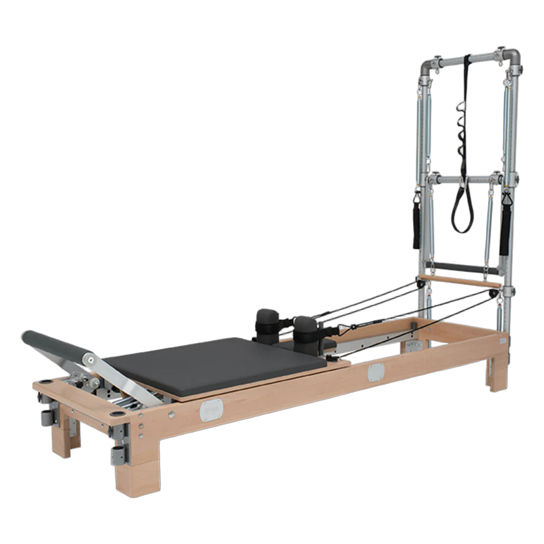 BASI Systems Reformer with Tower featuring adjustable pulleys, cushioned carriage, footbar, and push-through bar for professi